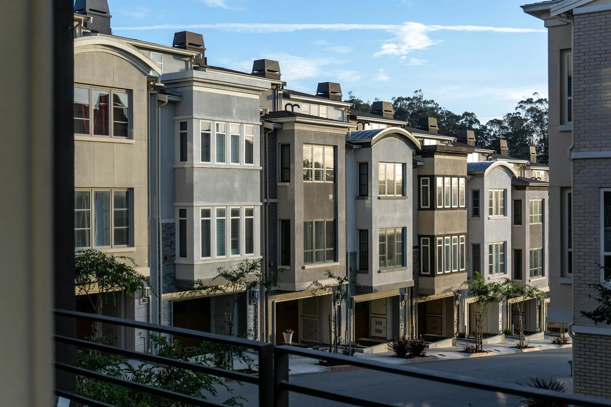 Row of multi-story townhomes along a street